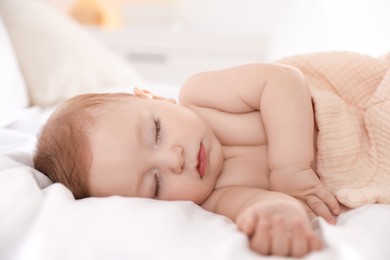 Cute little baby sleeping on bed at home