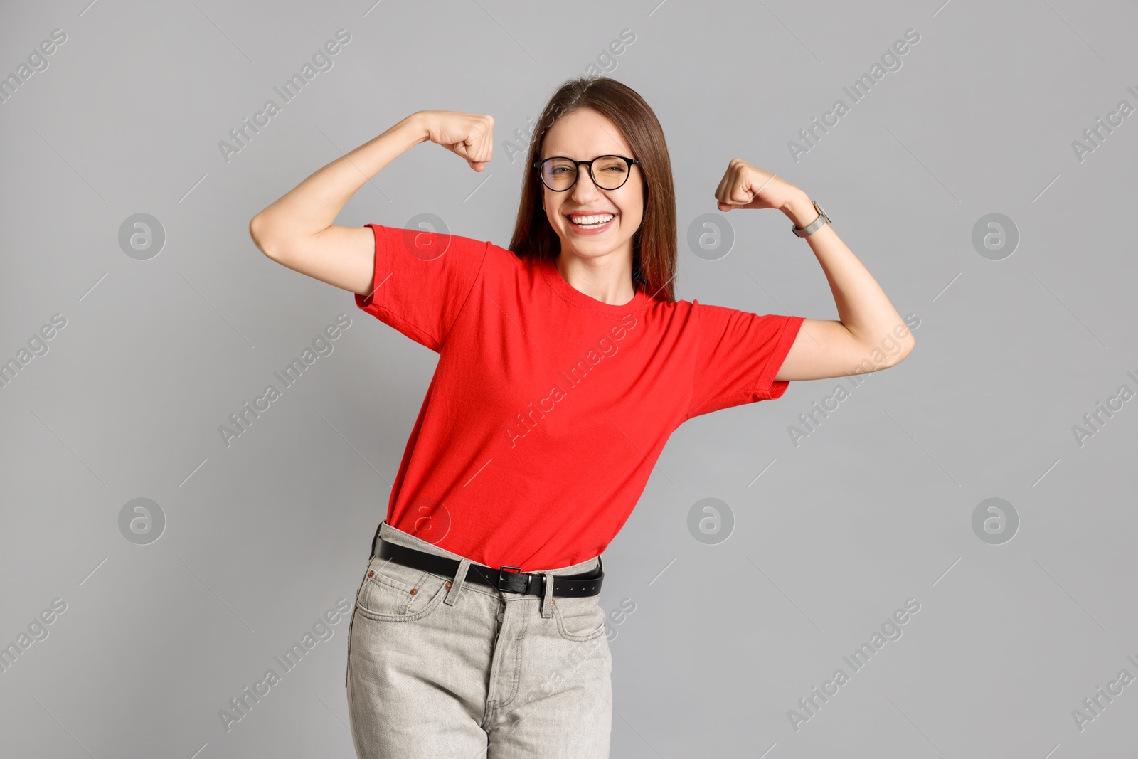 Photo of Portrait of happy winner on gray background