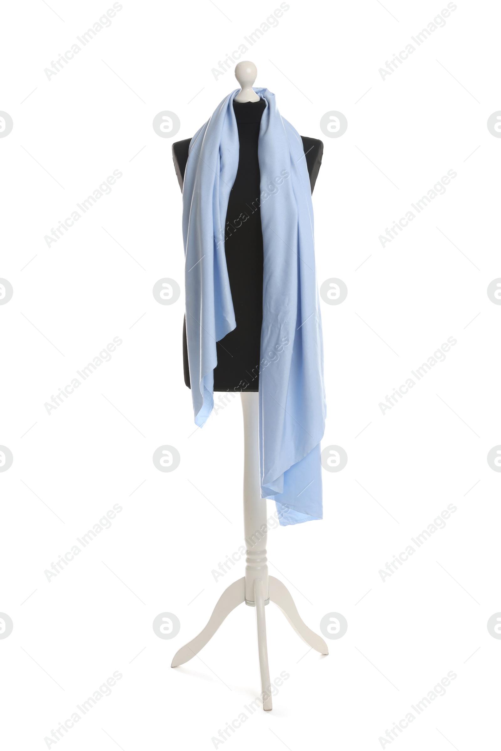 Photo of Draping light blue fabric on female mannequin against white background