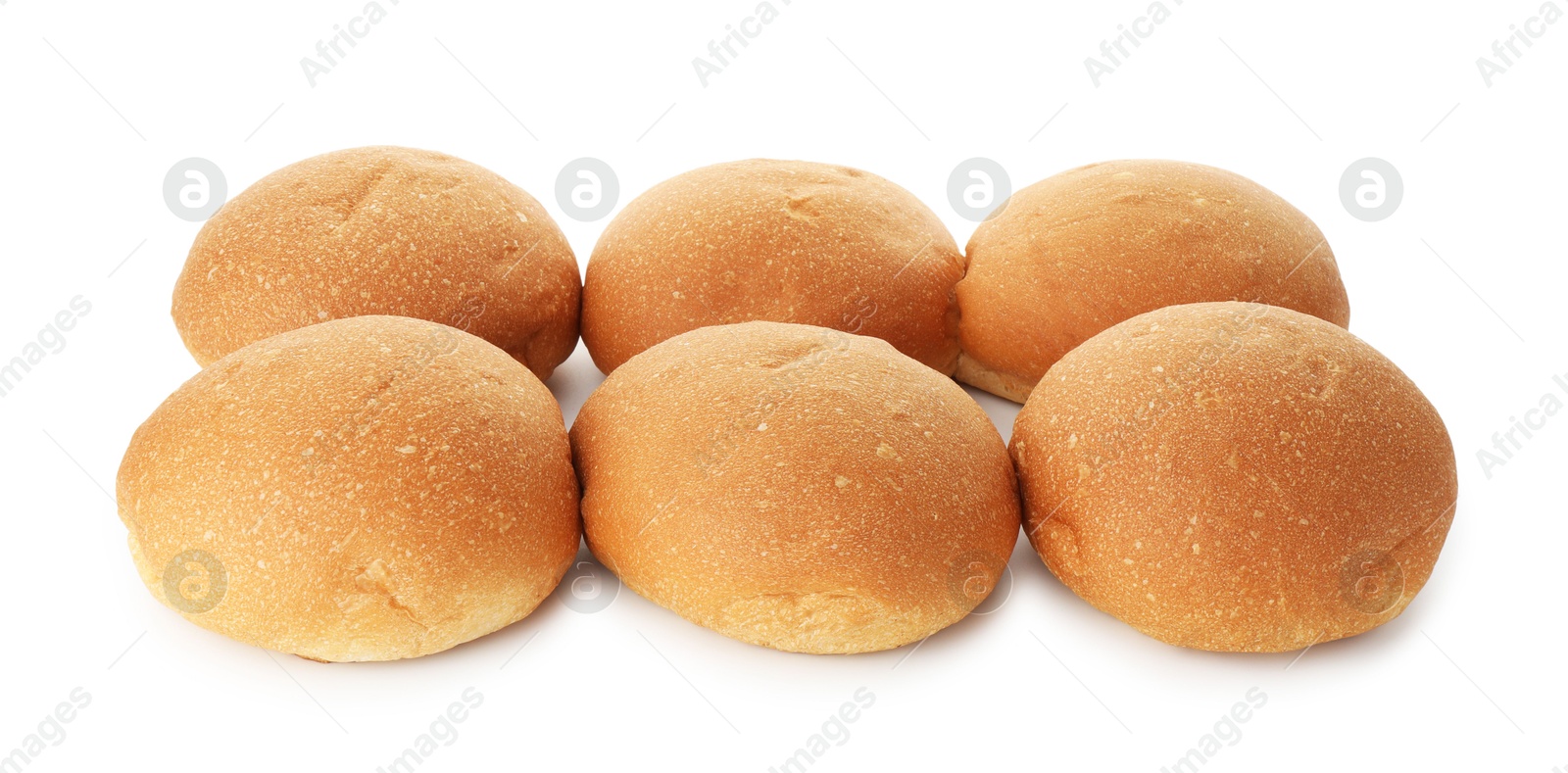 Photo of Many fresh tasty buns isolated on white