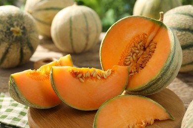 Photo of Tasty ripe Cantaloupe melons on table, closeup