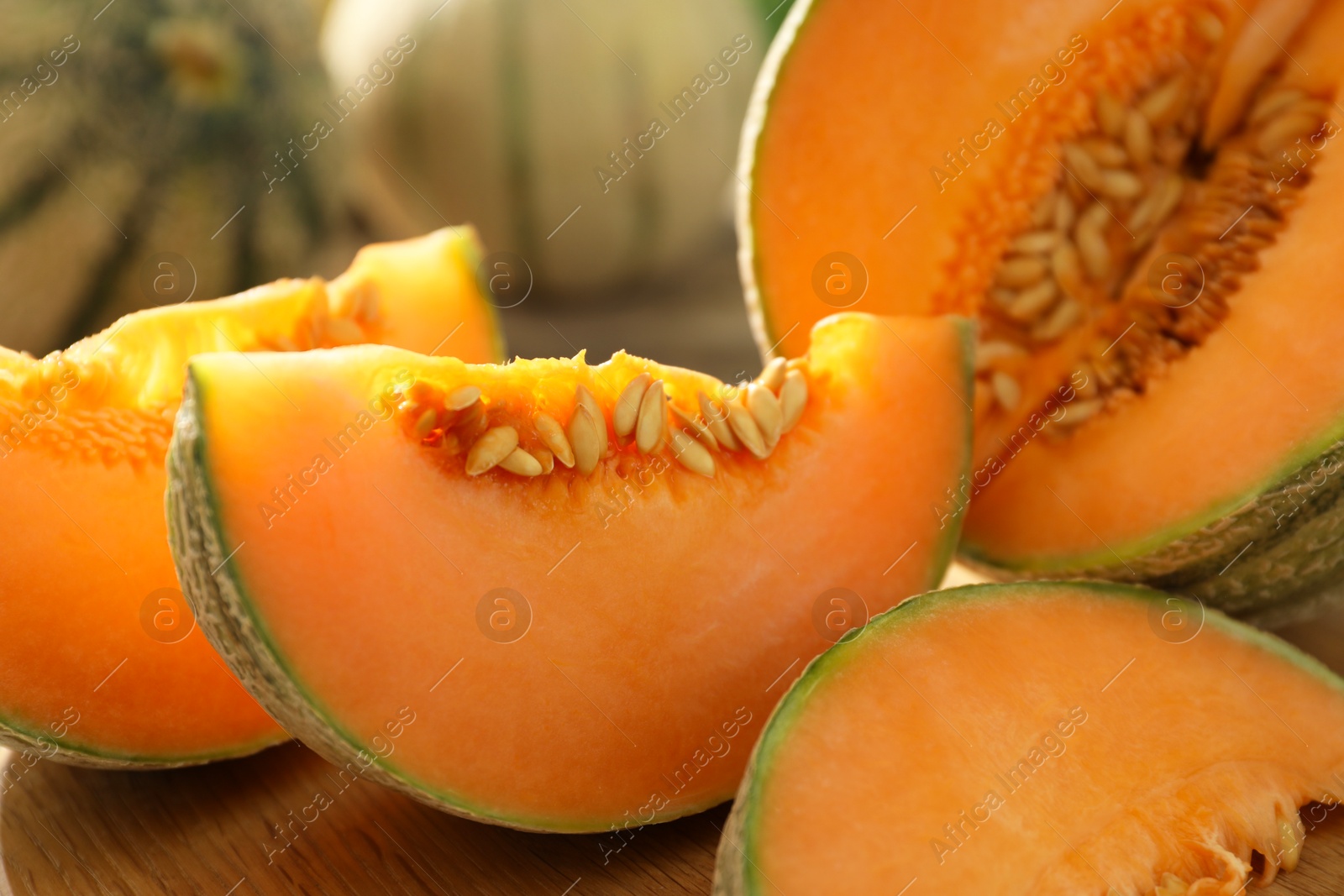 Photo of Cut ripe Cantaloupe melon on table, closeup