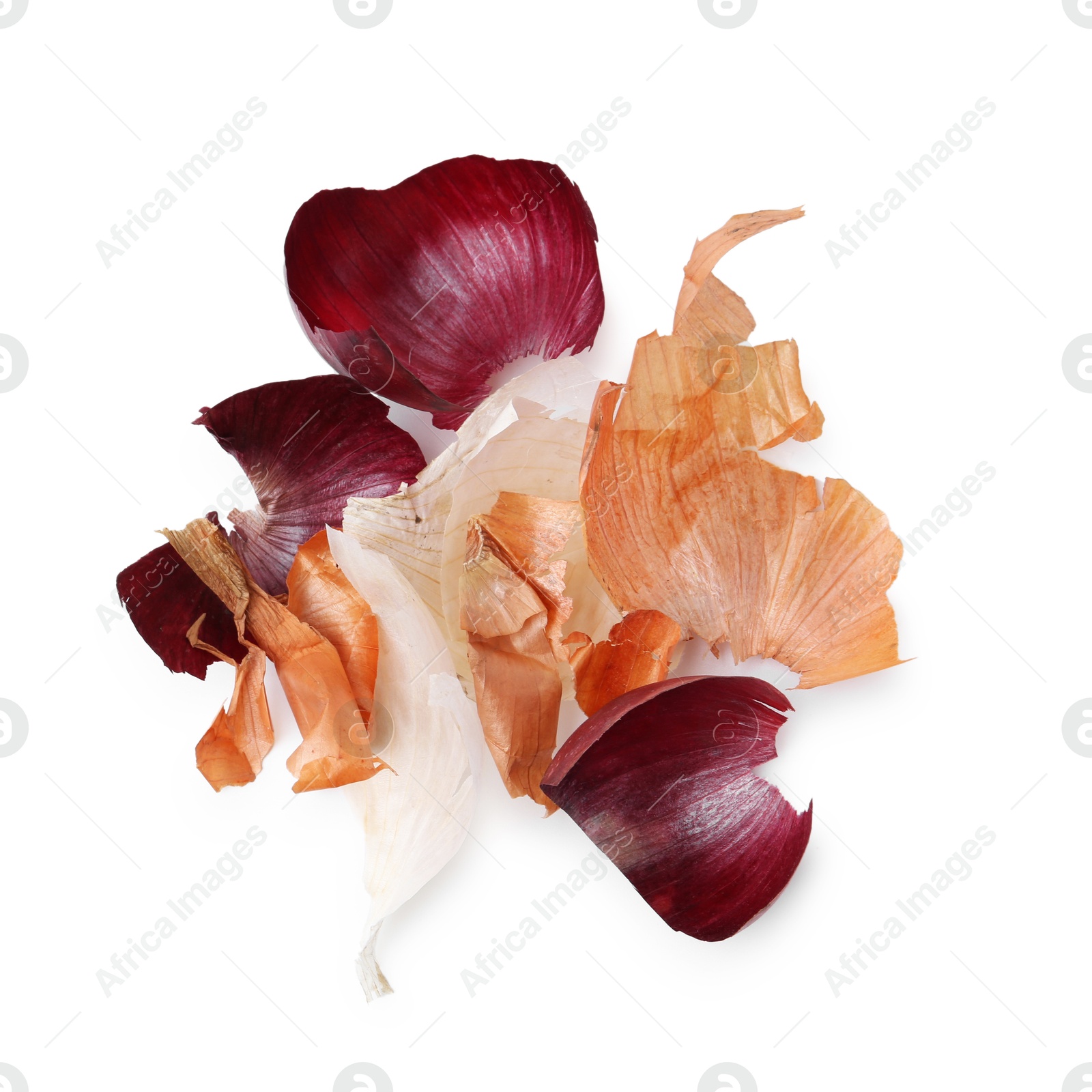 Photo of Pile of different onion peels isolated on white, top view