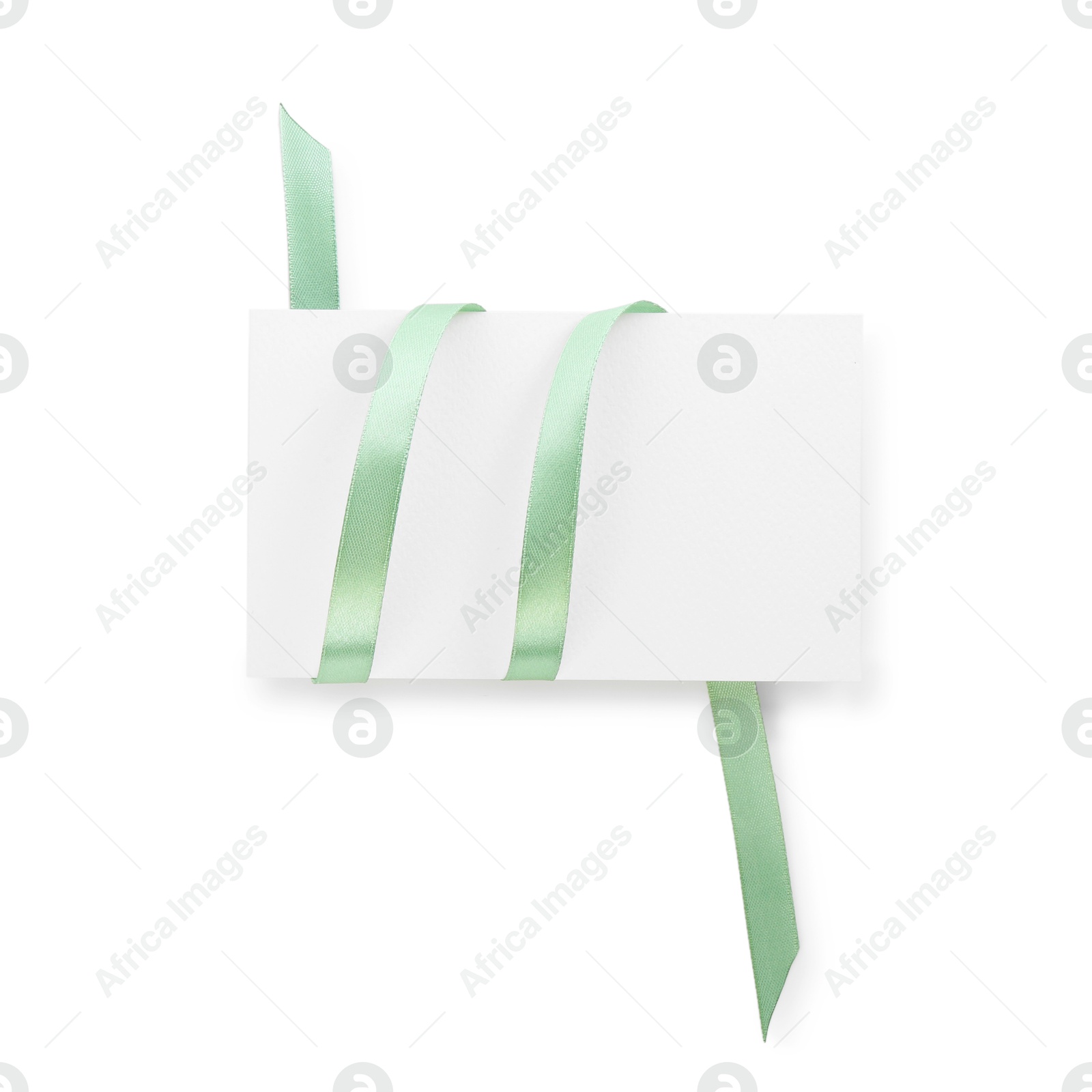 Photo of Blank card and ribbon isolated on white, top view