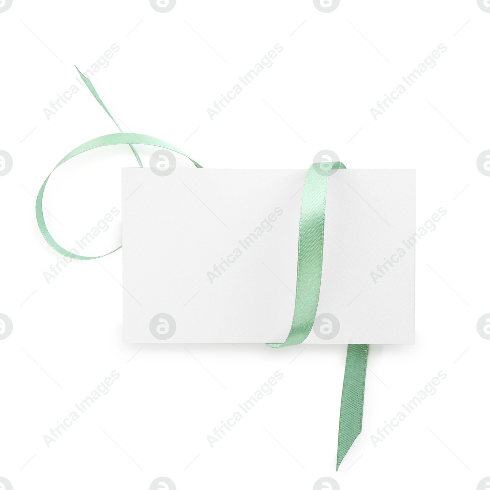 Photo of Blank card and ribbon isolated on white, top view