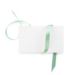 Photo of Blank card and ribbon isolated on white, top view