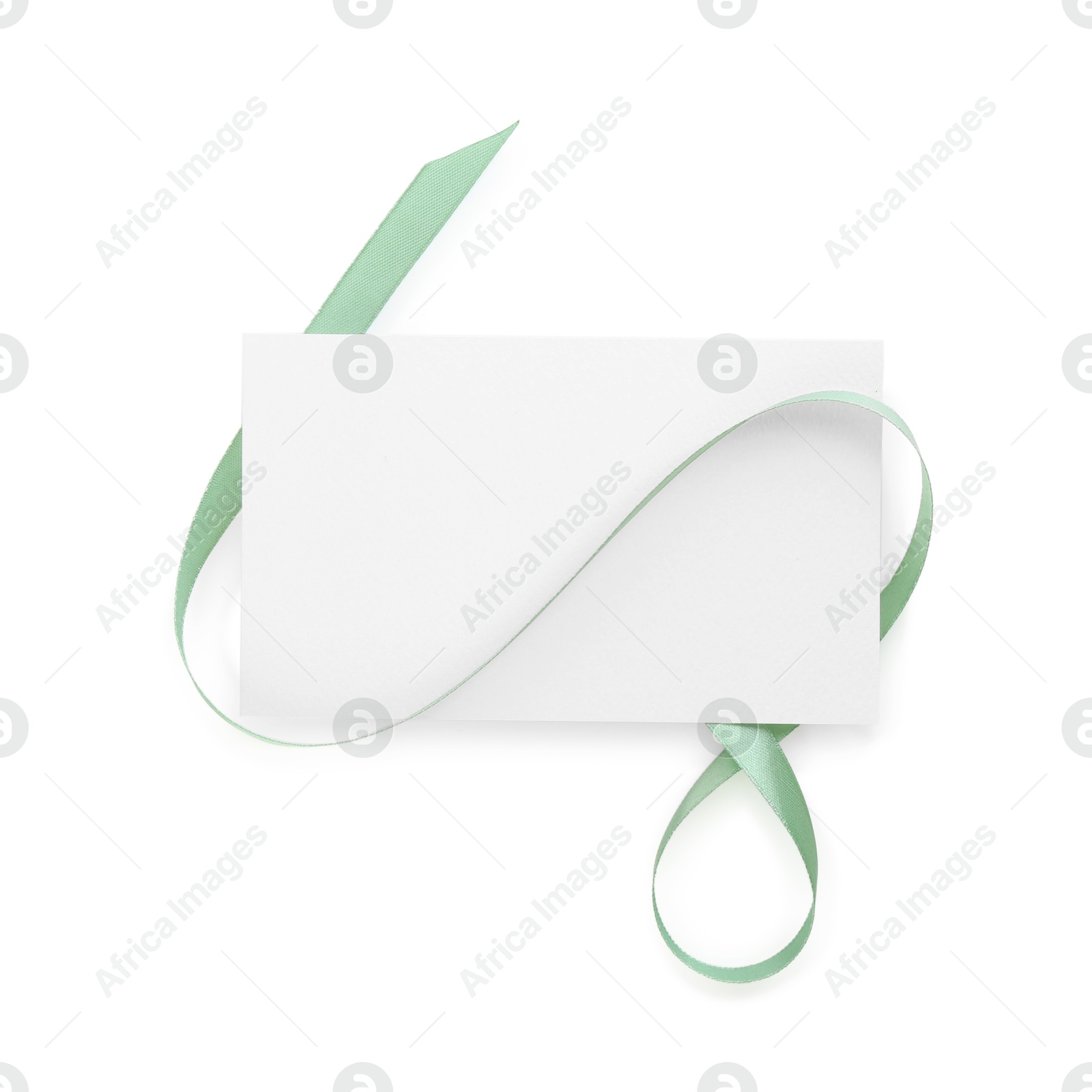 Photo of Blank card and ribbon isolated on white, top view