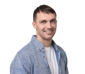 Smiling man with dental braces on white background