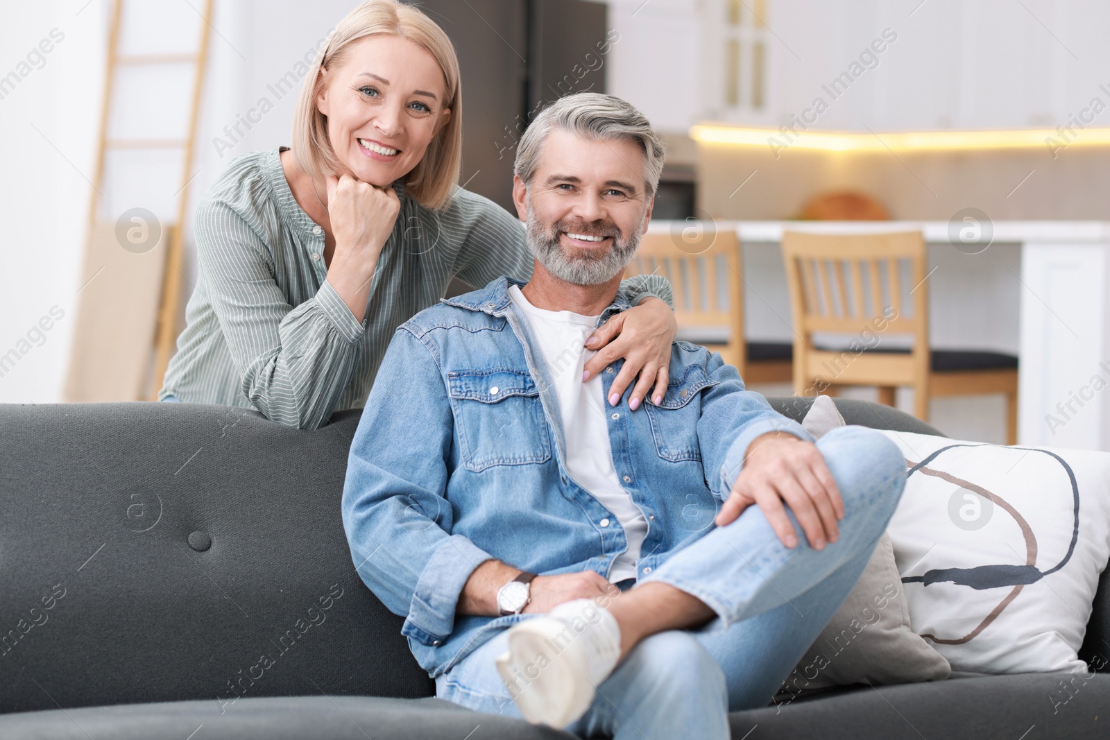 Photo of Portrait of happy middle aged couple in kitchen