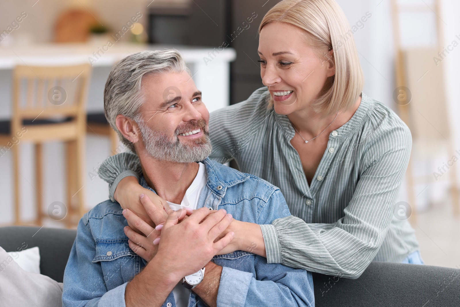 Photo of Portrait of happy middle aged couple in kitchen