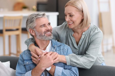 Portrait of happy middle aged couple in kitchen