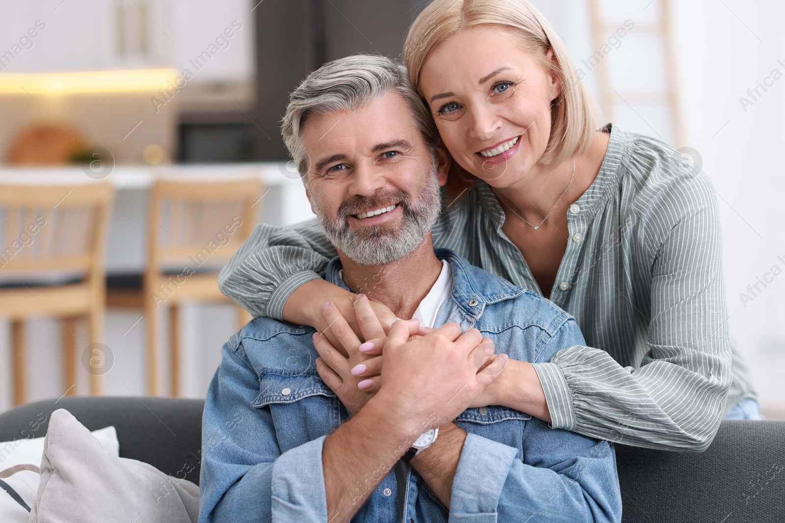 Photo of Portrait of happy middle aged couple in kitchen