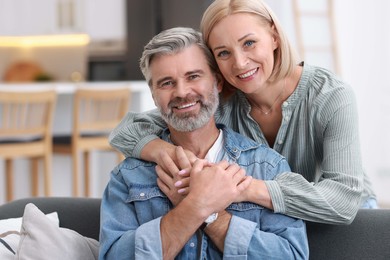 Portrait of happy middle aged couple in kitchen