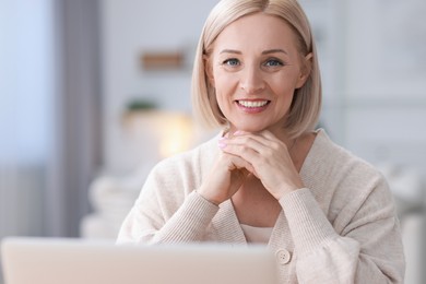 Photo of Portrait of happy middle aged woman indoors