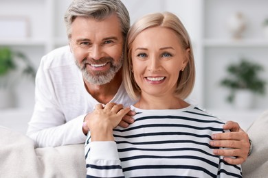 Photo of Portrait of happy middle aged couple at home