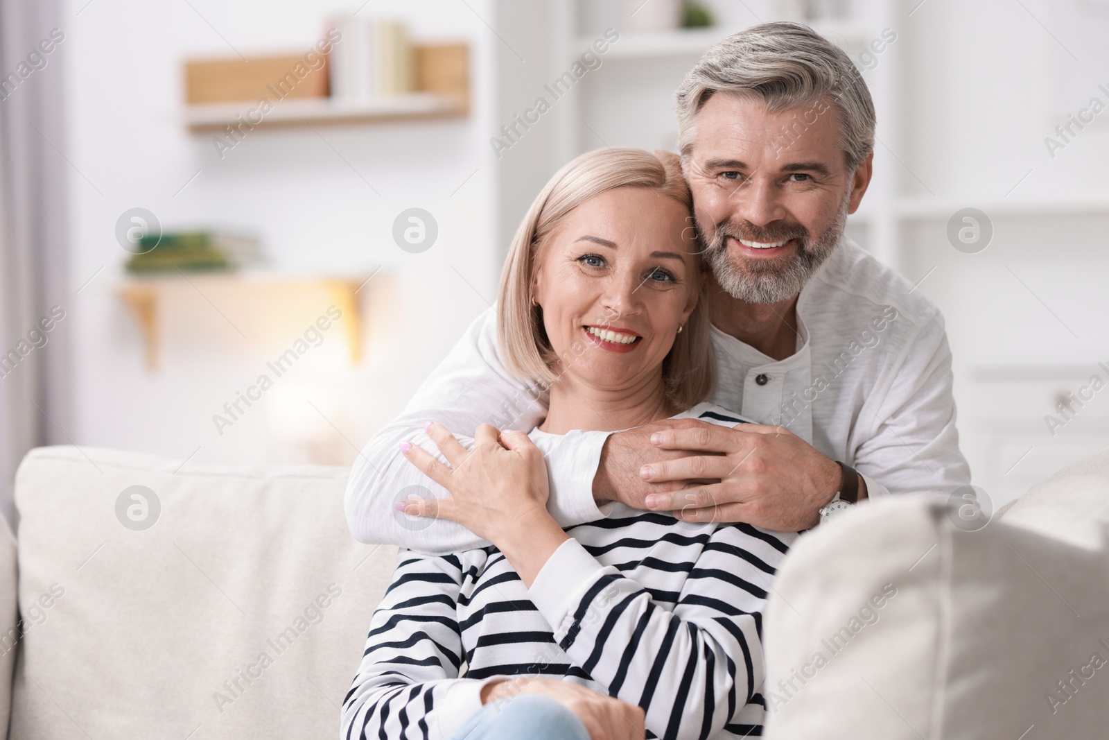 Photo of Portrait of happy middle aged couple at home