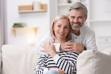 Portrait of happy middle aged couple at home