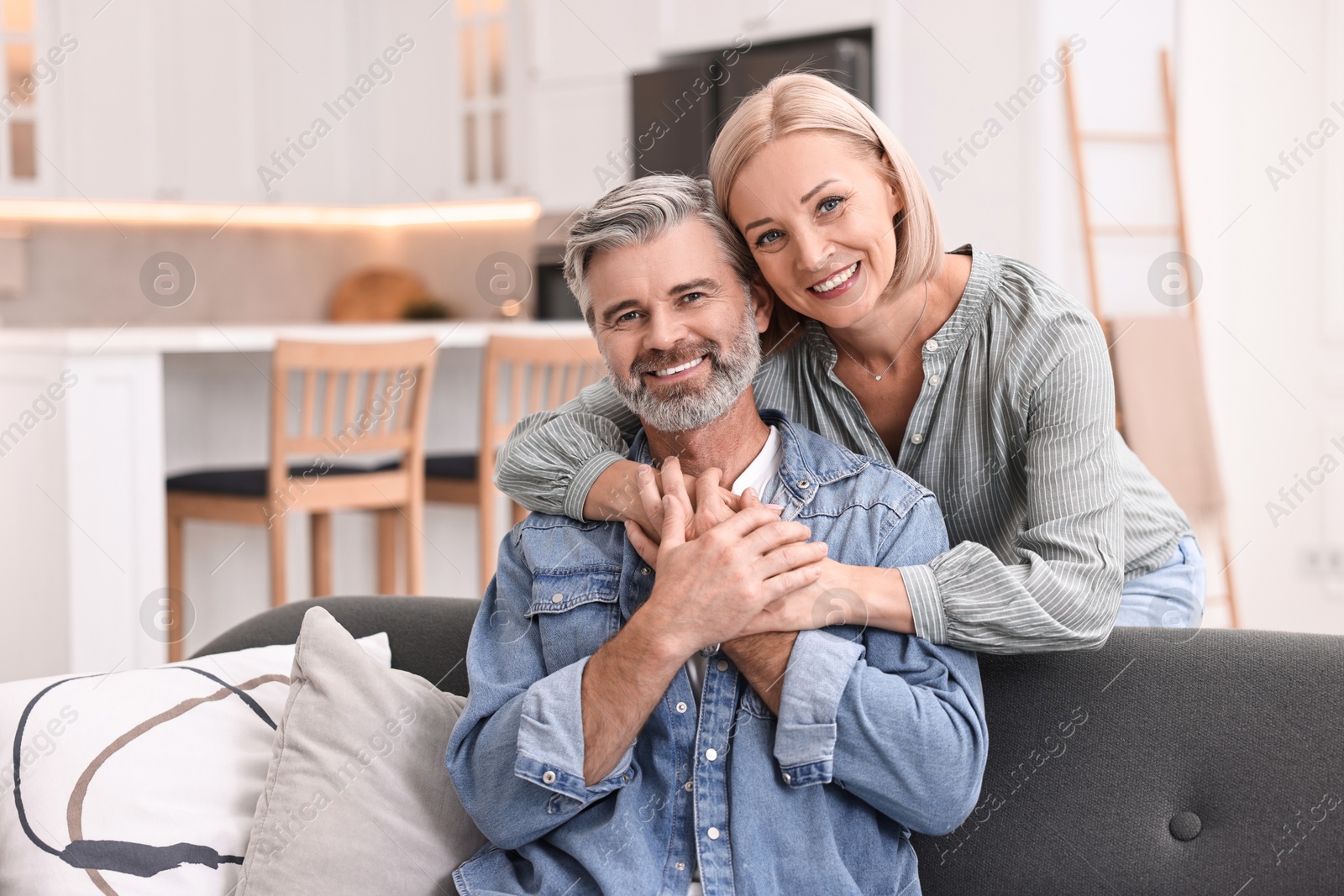 Photo of Portrait of happy middle aged couple in kitchen