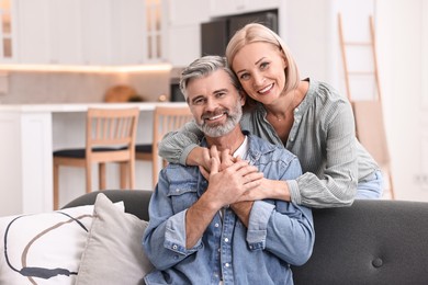 Portrait of happy middle aged couple in kitchen