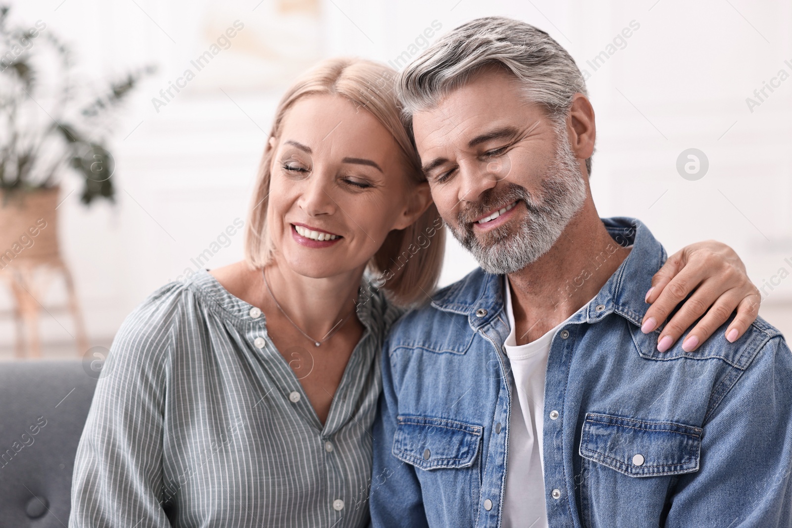 Photo of Portrait of happy middle aged couple at home