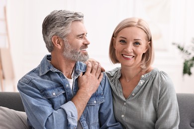 Portrait of happy middle aged couple at home