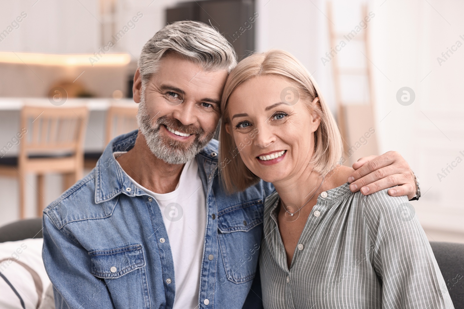 Photo of Portrait of happy middle aged couple at home