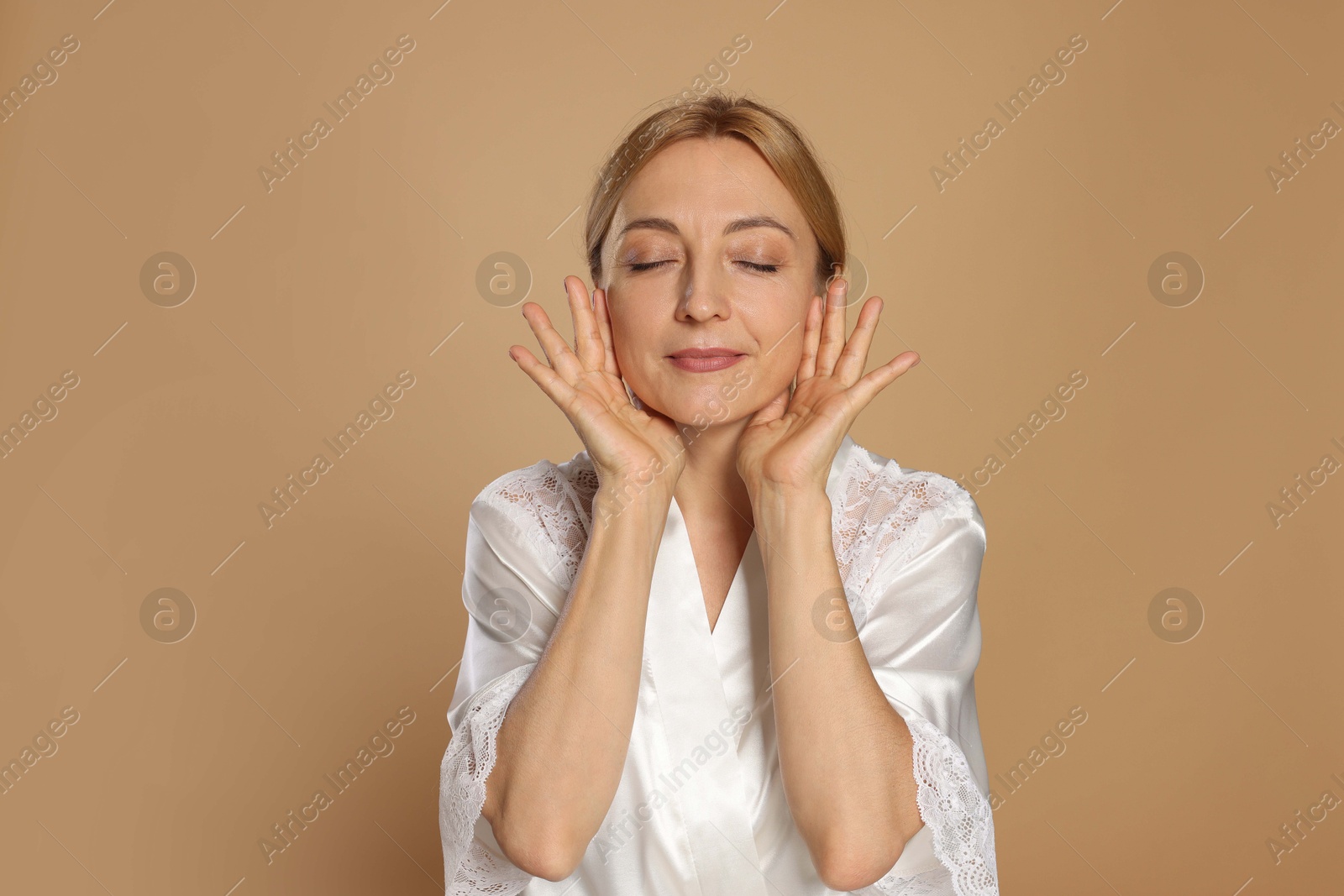 Photo of Portrait of beautiful woman with healthy skin on beige background