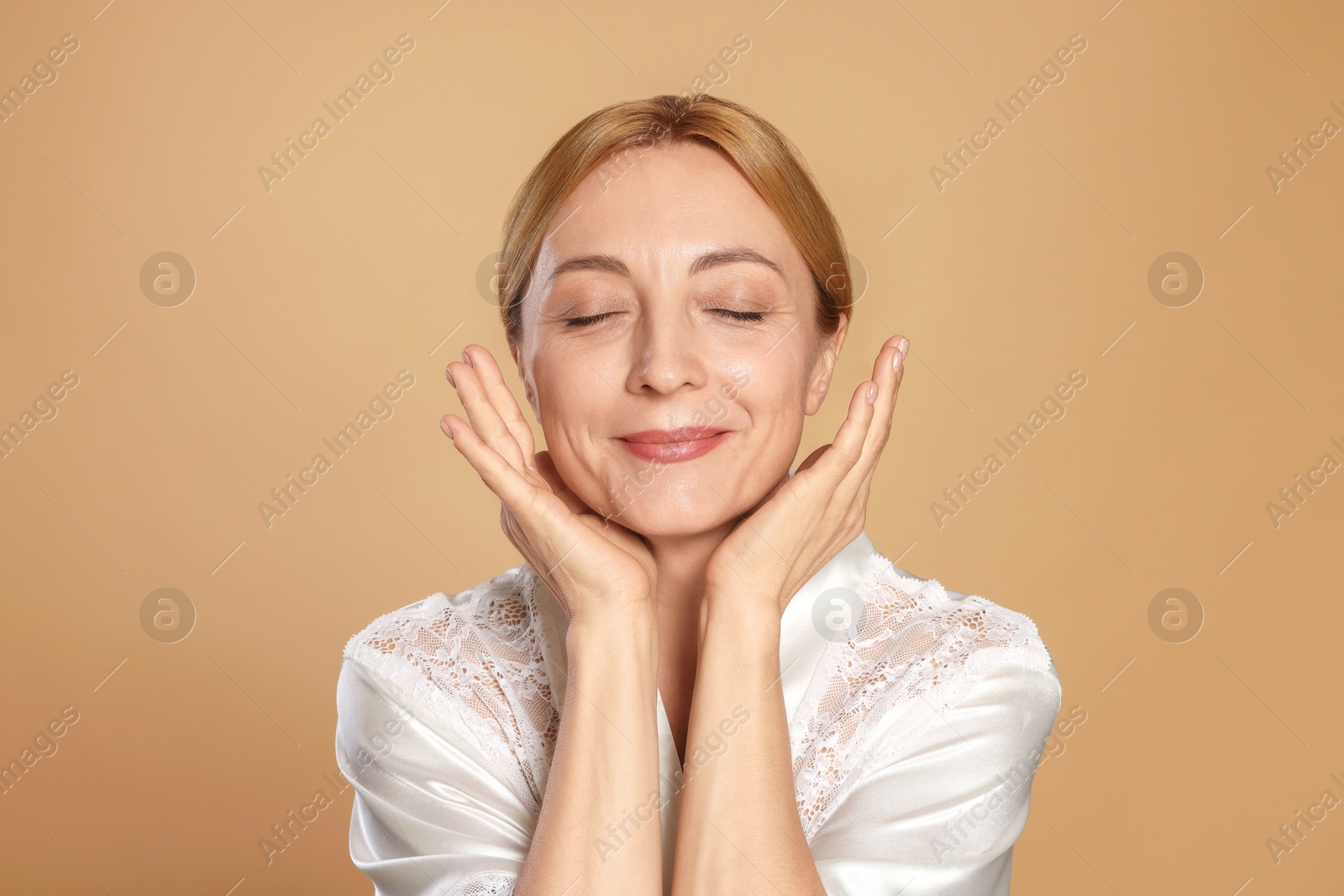 Photo of Portrait of beautiful woman with healthy skin on beige background