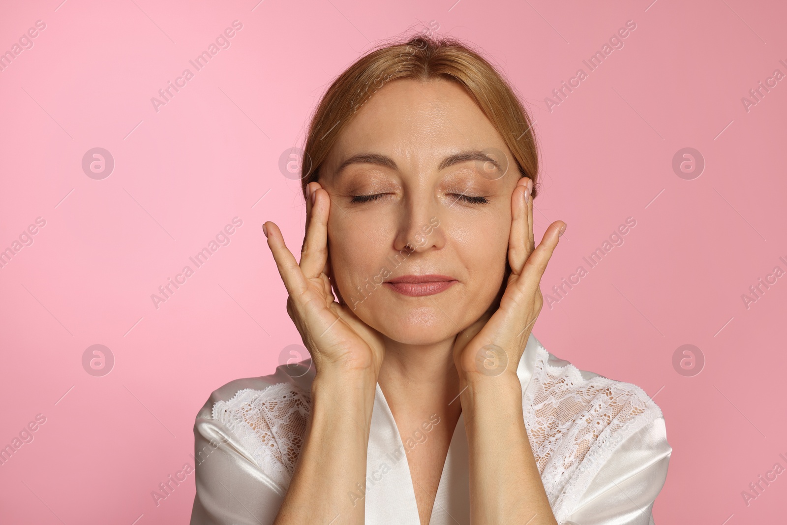 Photo of Portrait of beautiful woman with healthy skin on pink background