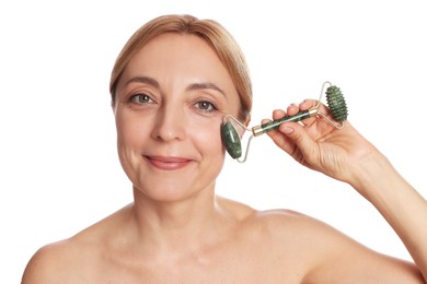 Photo of Beautiful woman doing facial self massage with roller on white background