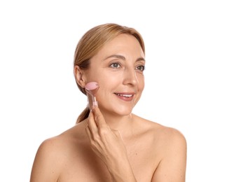 Smiling woman doing facial self massage with roller on white background