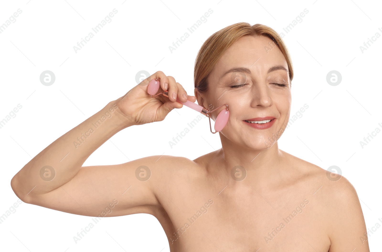 Photo of Smiling woman doing facial self massage with roller on white background