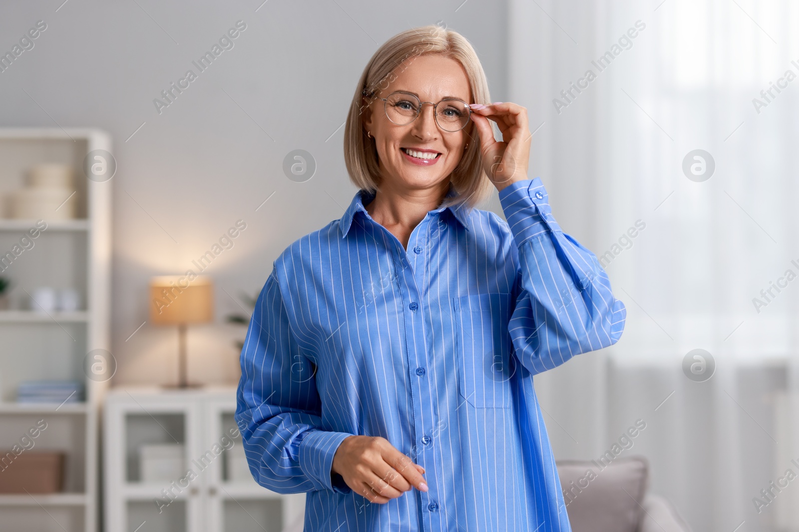 Photo of Portrait of smiling middle aged woman at home