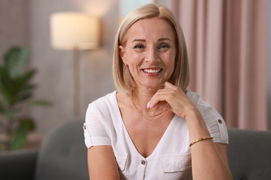 Photo of Portrait of smiling middle aged woman at home