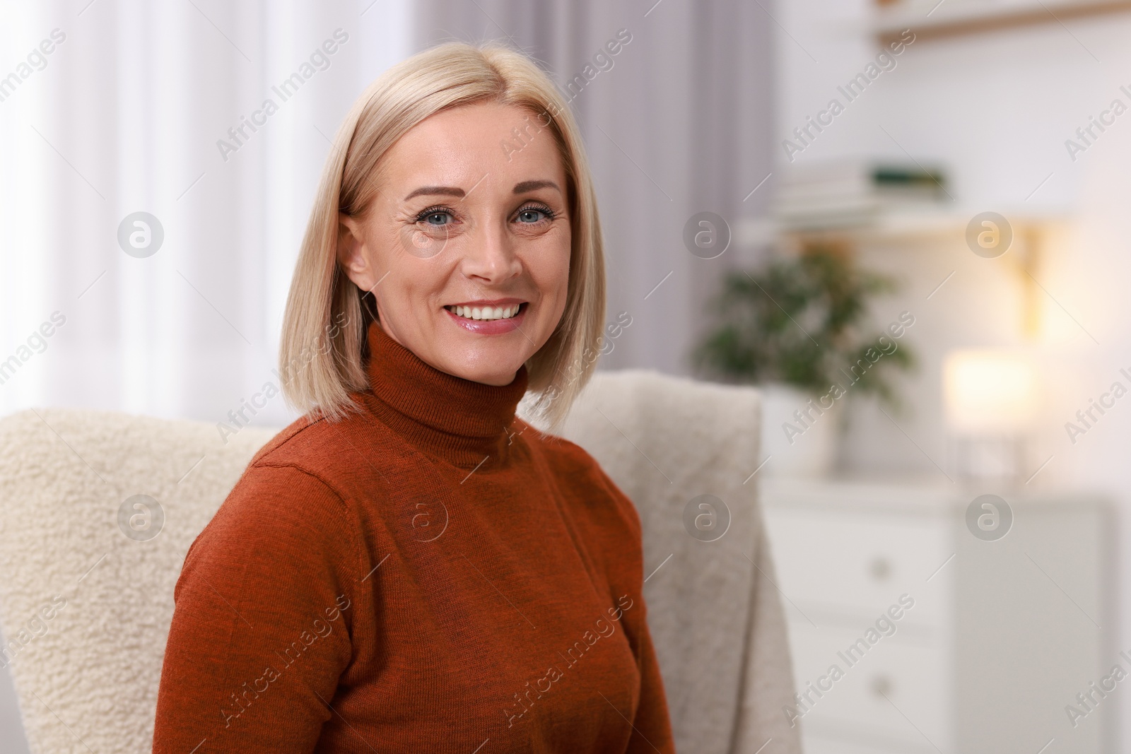 Photo of Portrait of smiling middle aged woman at home