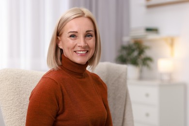 Portrait of smiling middle aged woman at home