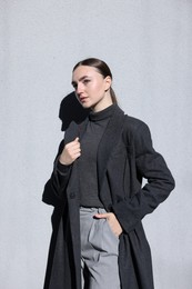 Beautiful young woman with posing on light grey background