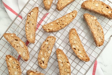 Photo of Traditional Italian almond biscuits (Cantucci) on white marble table, flat lay