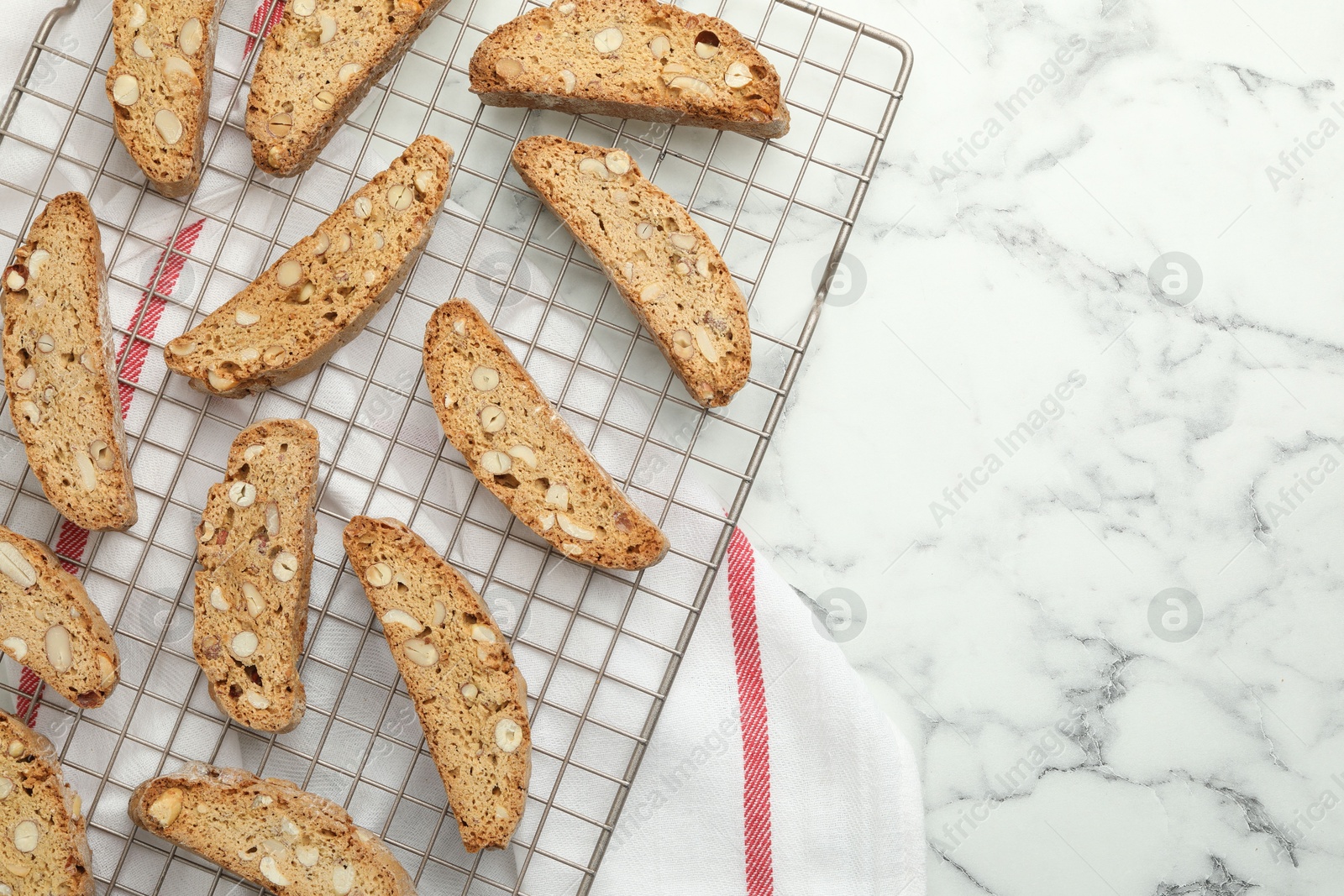 Photo of Traditional Italian almond biscuits (Cantucci) on white marble table, top view. Space for text