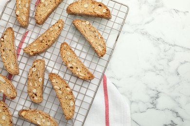 Photo of Traditional Italian almond biscuits (Cantucci) on white marble table, top view. Space for text