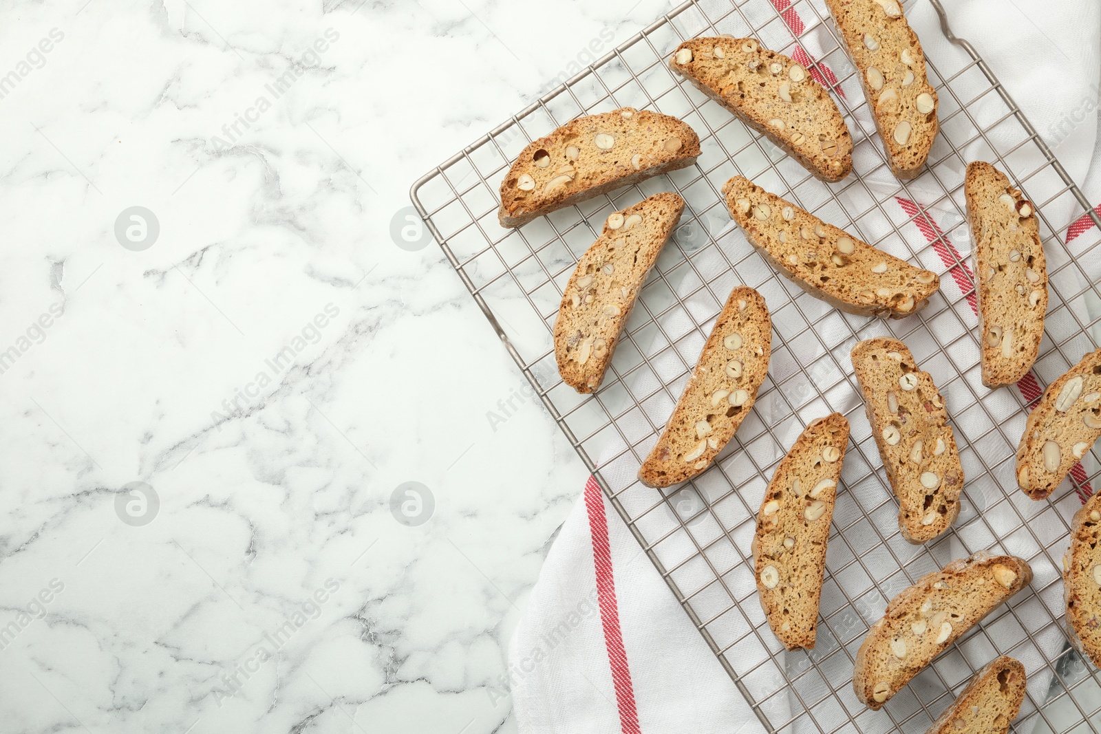 Photo of Traditional Italian almond biscuits (Cantucci) on white marble table, top view. Space for text