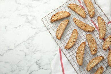 Photo of Traditional Italian almond biscuits (Cantucci) on white marble table, top view. Space for text