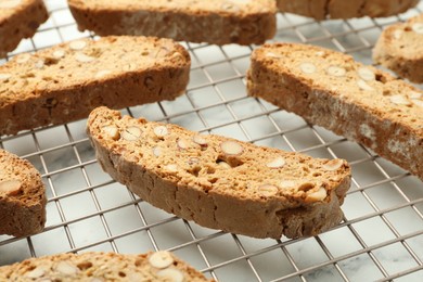 Photo of Traditional Italian almond biscuits (Cantucci) on white marble table, closeup