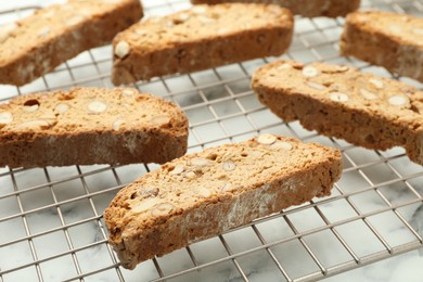 Photo of Traditional Italian almond biscuits (Cantucci) on white marble table, closeup