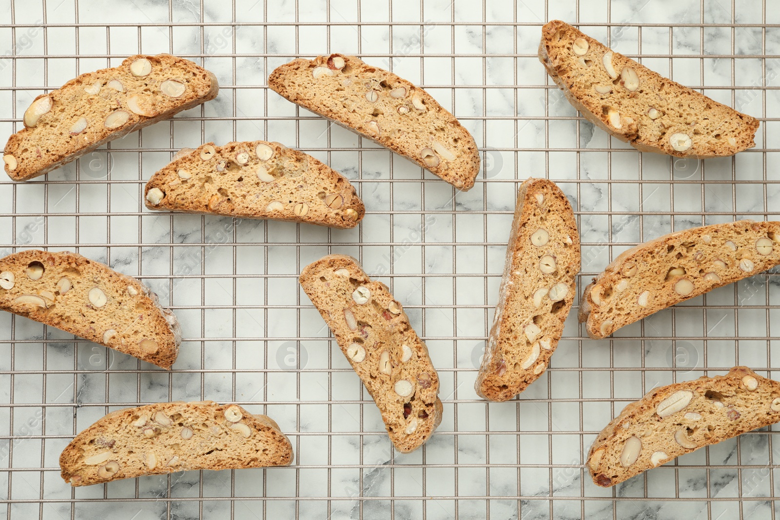 Photo of Traditional Italian almond biscuits (Cantucci) on white marble table, flat lay