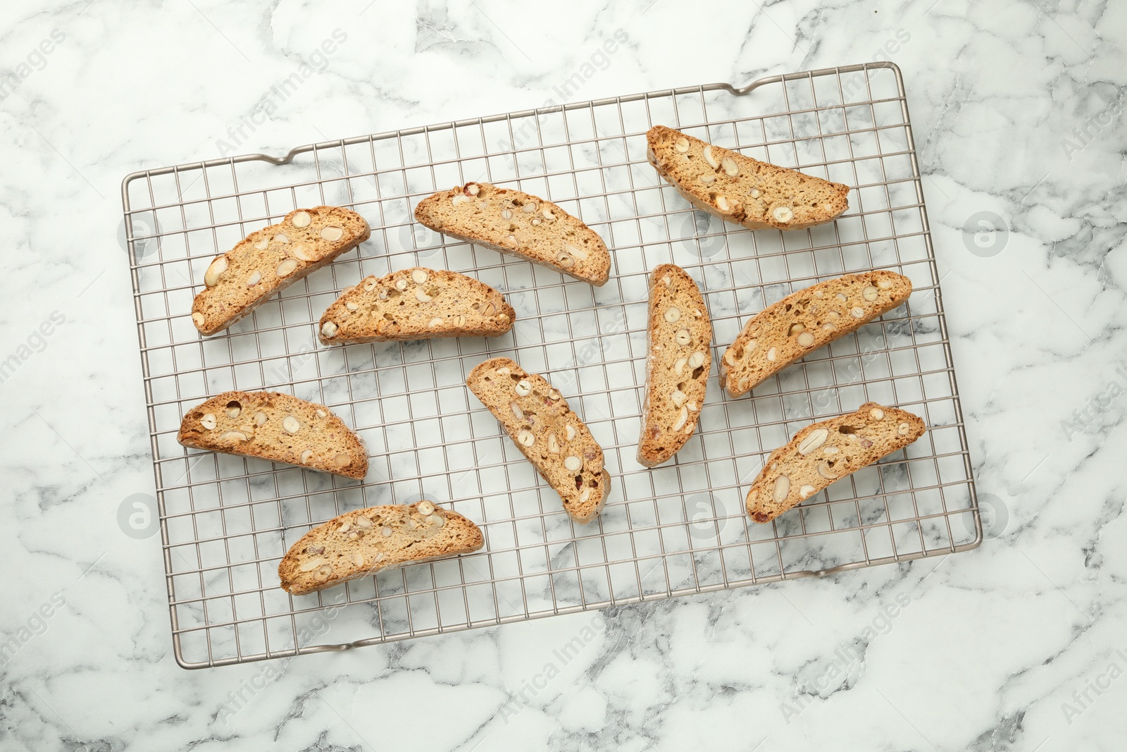 Photo of Traditional Italian almond biscuits (Cantucci) on white marble table, top view