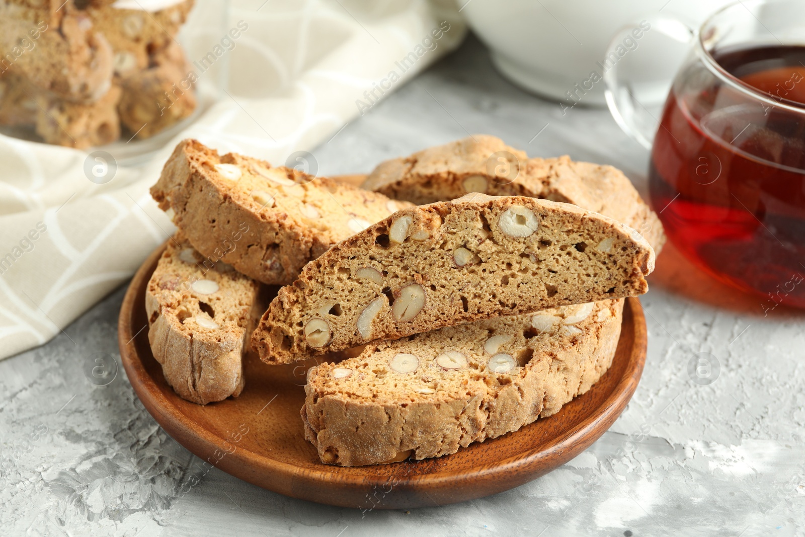 Photo of Traditional Italian almond biscuits (Cantucci) on grey textured table, closeup