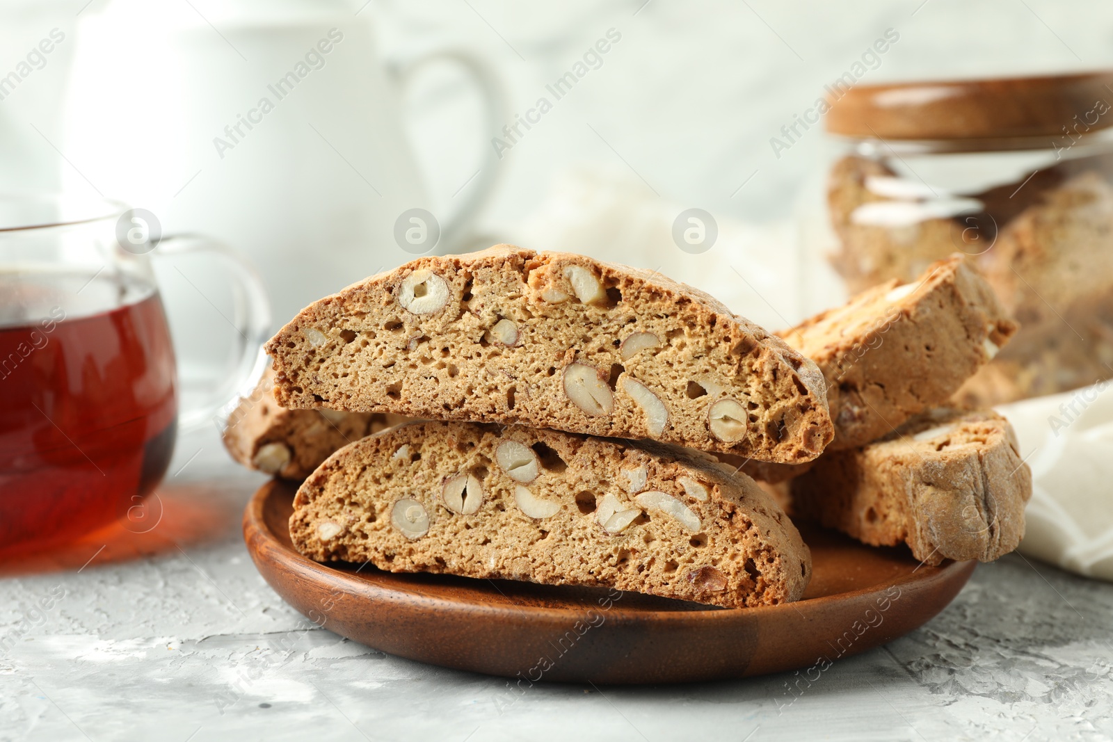 Photo of Traditional Italian almond biscuits (Cantucci) on grey textured table, closeup