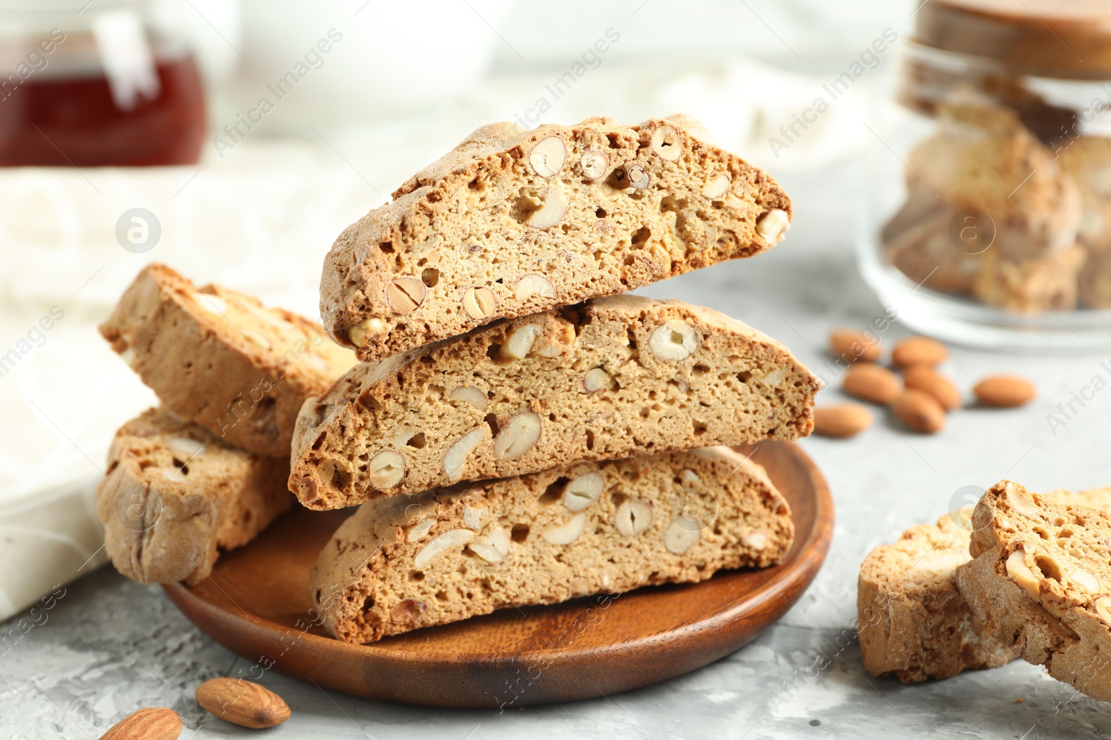 Photo of Traditional Italian almond biscuits (Cantucci) on grey textured table, closeup