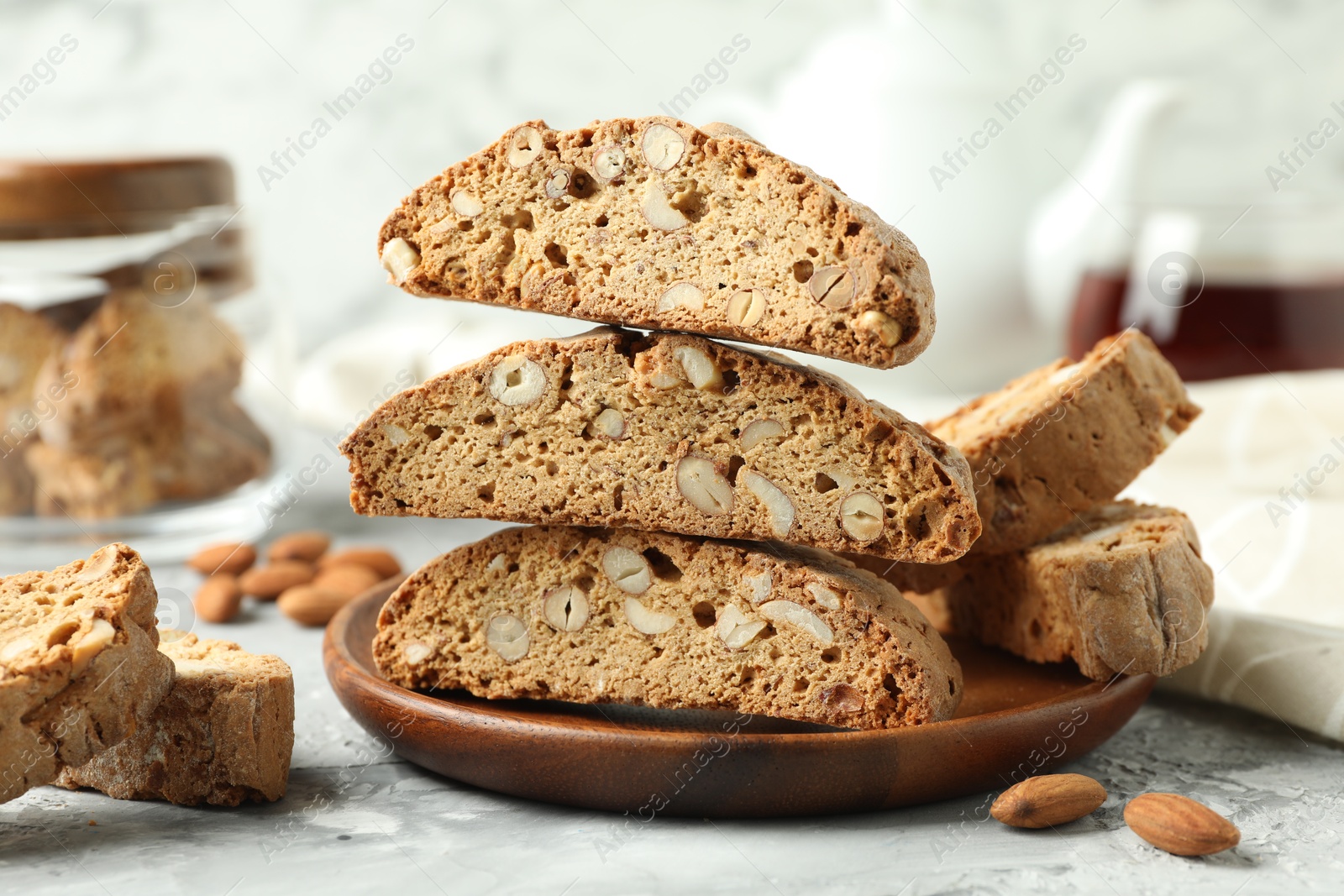 Photo of Traditional Italian almond biscuits (Cantucci) on grey textured table, closeup